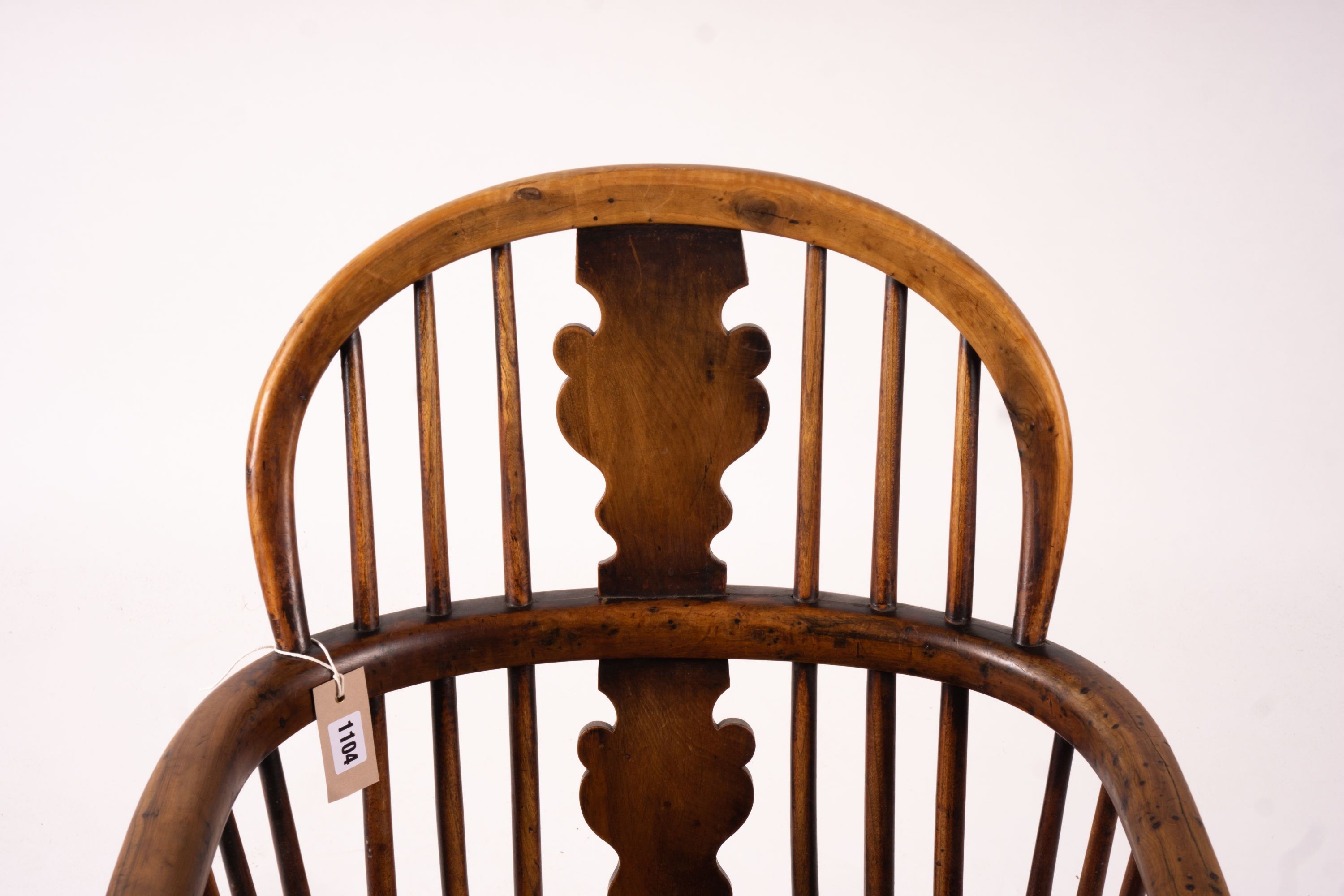 A mid 19th century yew and elm Windsor elbow chair with crinoline stretcher, width 54cm, depth 46cm, height 94cm